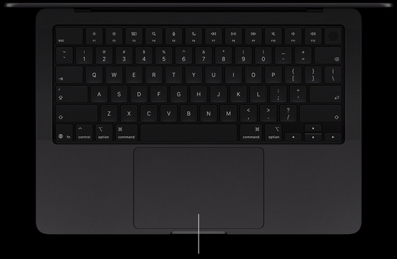 MacBook Pro with PROLED XDR Display, space black color, open, showing keyboard and Force Touch trackpad
