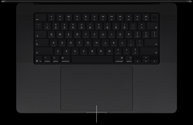 MacBook Pro with PROLED XDR Display, space black color, open, showing keyboard and Force Touch trackpad